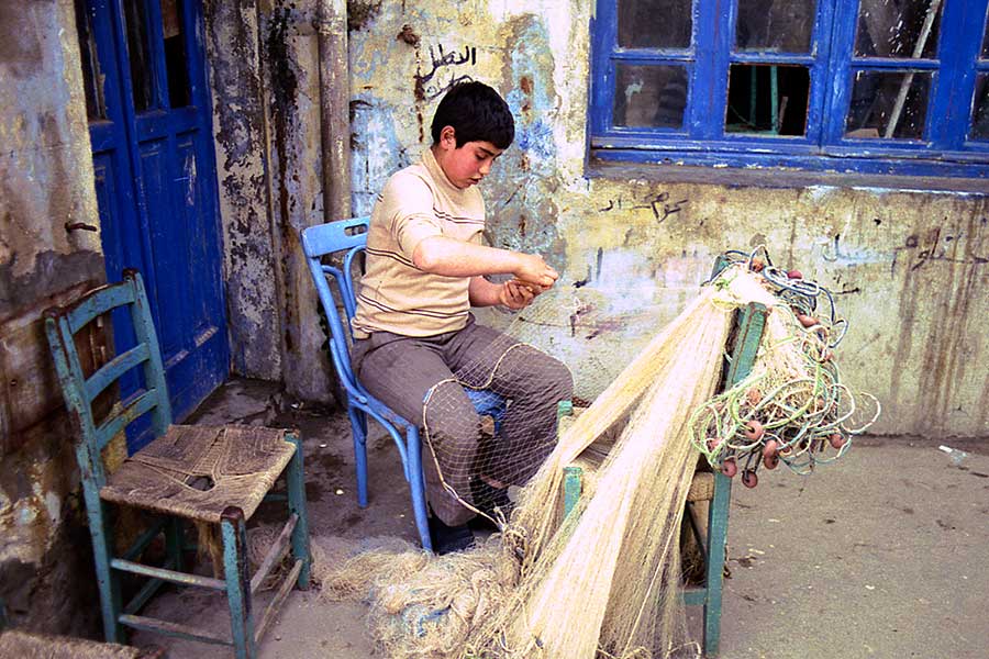 Boy Mending a Fishing Net in Tartus, Syria