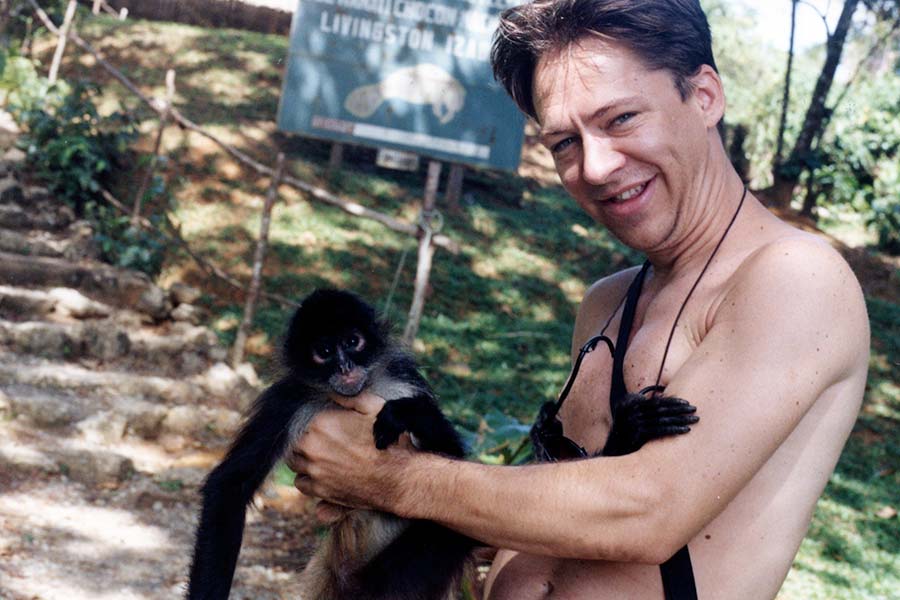 Photo of Darrell Chaddock With a Spider Monkey in Guatemala