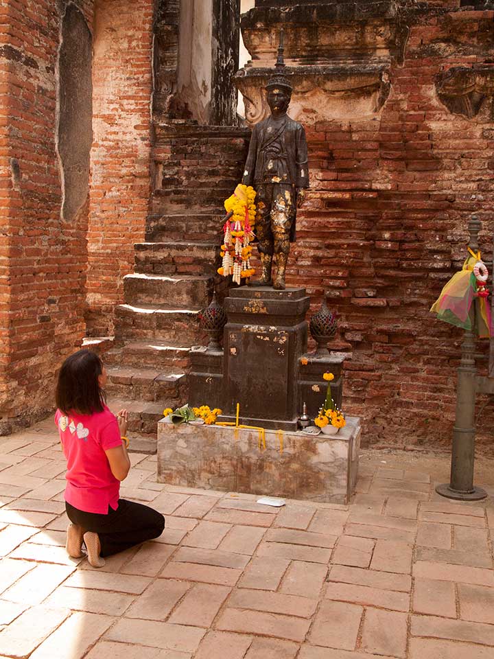 Woman Worshiping at a Ruined Temple in Lopburi, Thailand