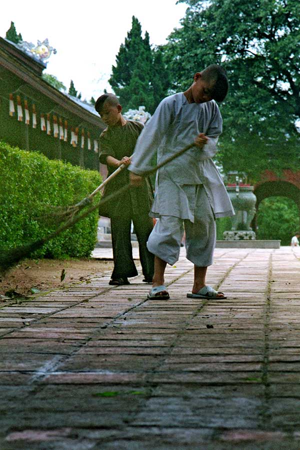Boys Sweeping Leaves at the Thien Mu Pagoda, Hue, Viet Nam