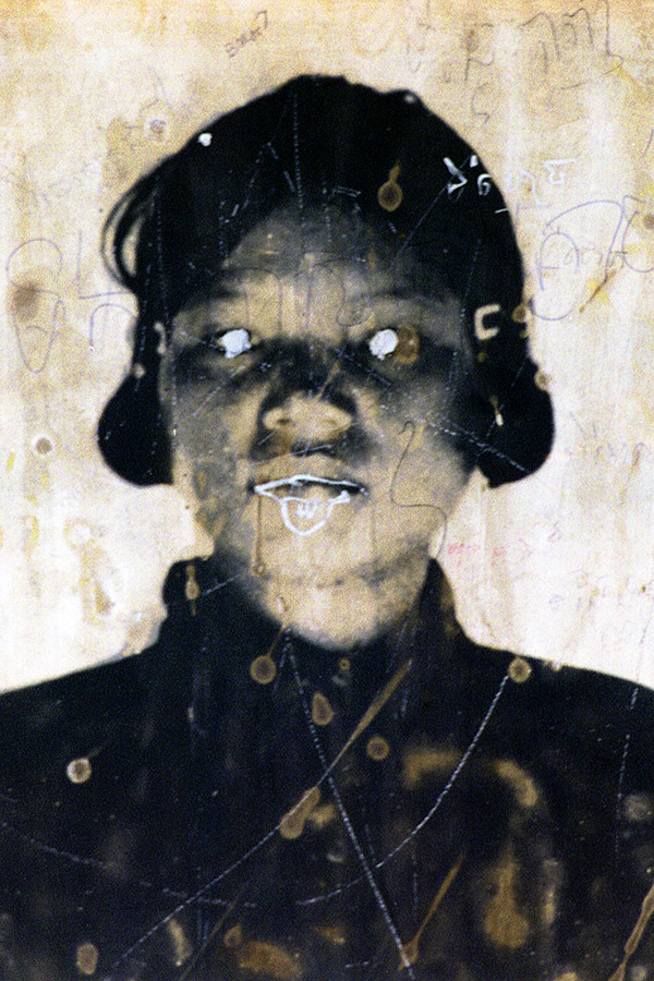 Defaced Photo of Former Khmer Rouge Guard at Toul Sleng Genocide Museum, Phnom Pehn, Cambodia