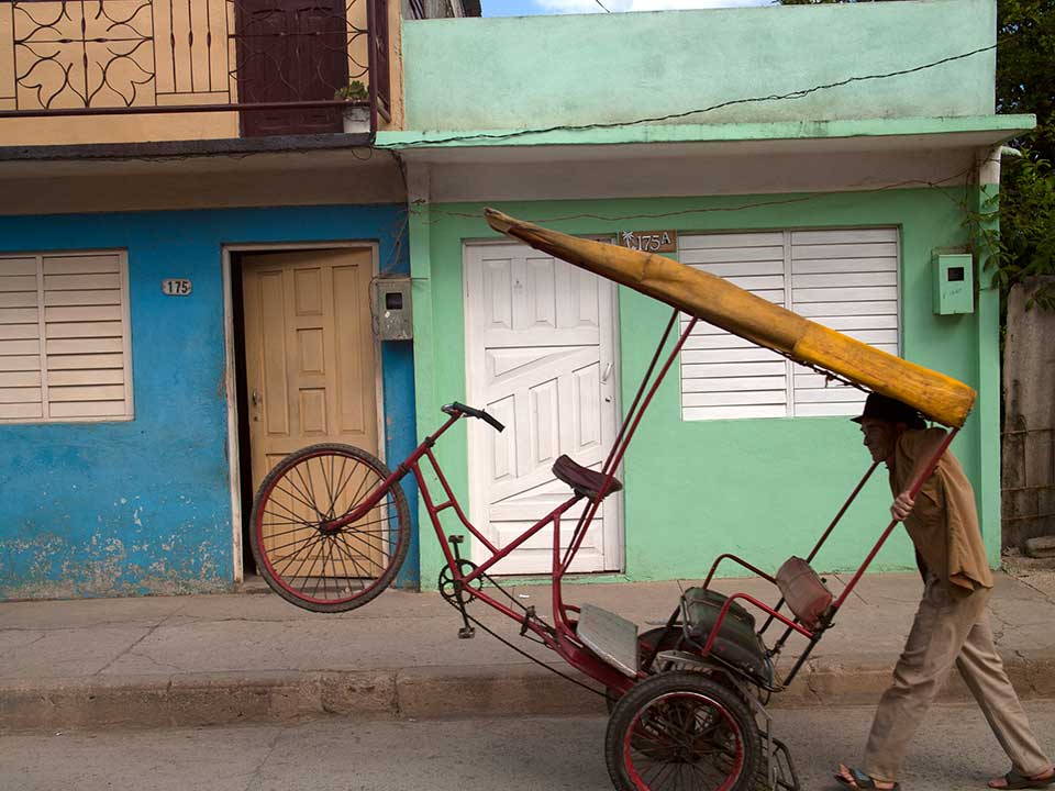 Man Pushing a Bicycle Taxi in Baracoa, Cuba