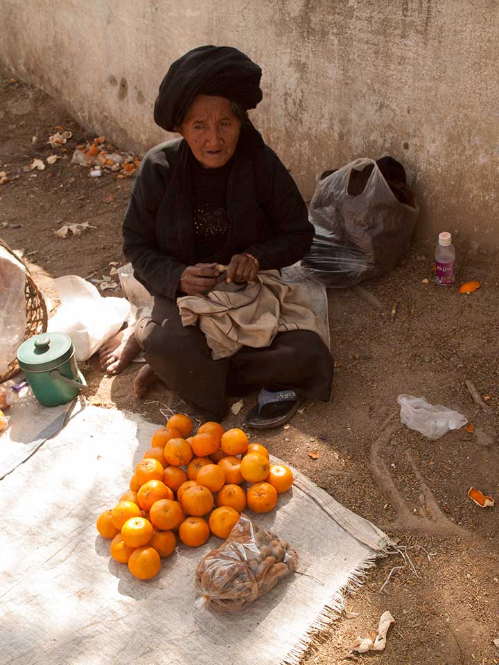 Old Woman Selling Oranges and Tamarind in Kentung, Myanmar